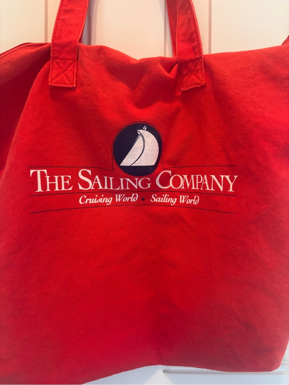 Red tote bag zip top The Sailing Company Logo; sailing world, cruising world